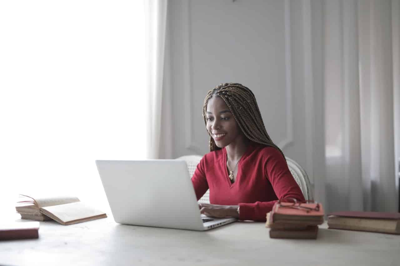 certificado digital mullher de cabelo longo blusa vermelha e um macbook air